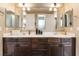 Bathroom featuring double sink vanity, dark wood cabinets, and large mirrors at 1013 Baronet Dr, Las Vegas, NV 89138