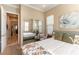 Relaxing bedroom featuring a large mirror, floral accents, and comfortable furnishings at 1013 Baronet Dr, Las Vegas, NV 89138