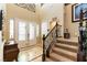 Bright foyer features staircase, high ceilings, tile and carpet flooring and double glass doors at 1013 Baronet Dr, Las Vegas, NV 89138