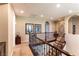 Upstairs hallway featuring carpeted flooring, wrought iron bannister, and decorative wall art at 1013 Baronet Dr, Las Vegas, NV 89138