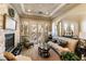 Comfortable living room with stone fireplace, plush seating, and bright natural light at 1013 Baronet Dr, Las Vegas, NV 89138