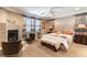 Spacious main bedroom featuring fireplace, seating area, and stylish decor at 1013 Baronet Dr, Las Vegas, NV 89138