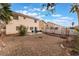 Large backyard featuring gravel, patio area and lush landscaping at 1017 Cliffbrook Hedge Ave, North Las Vegas, NV 89081
