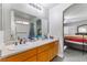 Bathroom featuring a single sink vanity, large mirror, and tub-shower with grab bars at 1017 Cliffbrook Hedge Ave, North Las Vegas, NV 89081