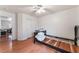 Bright bedroom featuring wood floors, ceiling fan and closet at 1017 Cliffbrook Hedge Ave, North Las Vegas, NV 89081