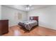 Cozy bedroom with hardwood floors, ceiling fan, and a comfortable bed at 1017 Cliffbrook Hedge Ave, North Las Vegas, NV 89081