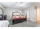 Cozy bedroom featuring neutral walls, tile flooring, and a comfortable bed setup at 1017 Cliffbrook Hedge Ave, North Las Vegas, NV 89081