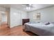 Well-lit bedroom with a ceiling fan, wood flooring, and a comfortable bed at 1017 Cliffbrook Hedge Ave, North Las Vegas, NV 89081