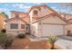 Charming two-story home features a well-maintained front yard and an attached two-car garage at 1017 Cliffbrook Hedge Ave, North Las Vegas, NV 89081