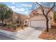This house features a well-maintained front yard, desert landscaping, and an attached two-car garage at 1017 Cliffbrook Hedge Ave, North Las Vegas, NV 89081