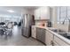 Bright kitchen featuring stainless steel appliances, white cabinets, and an open view to the dining and living areas at 1017 Cliffbrook Hedge Ave, North Las Vegas, NV 89081