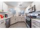 Efficient kitchen features stainless steel appliances, ample countertop space, and bright natural light at 1017 Cliffbrook Hedge Ave, North Las Vegas, NV 89081