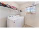 Bright laundry room featuring a washer, dryer and window at 1017 Cliffbrook Hedge Ave, North Las Vegas, NV 89081