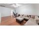 Upstairs seating area features hardwood floors, ceiling fan, and a neutral-toned sofa with accent pillows at 1017 Cliffbrook Hedge Ave, North Las Vegas, NV 89081