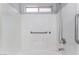 Clean, tiled shower and tub featuring grab bars and shower head at 1017 Cliffbrook Hedge Ave, North Las Vegas, NV 89081