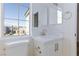 Well-lit bathroom with tile countertop, a sink, and ample natural light from a nearby window at 1021 Gary Carmena Ave, North Las Vegas, NV 89081