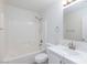 Bathroom with tub shower, white tiling, and single sink vanity at 1021 Gary Carmena Ave, North Las Vegas, NV 89081