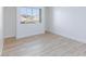 Bright bedroom features a large window offering natural light and wood-look flooring at 1021 Gary Carmena Ave, North Las Vegas, NV 89081
