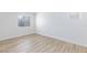 Neutral bedroom featuring light wood flooring and a window at 1021 Gary Carmena Ave, North Las Vegas, NV 89081