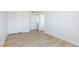A bedroom features light wood flooring, closet and two doors, and white walls at 1021 Gary Carmena Ave, North Las Vegas, NV 89081
