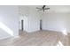 Spacious bedroom with a ceiling fan and light wood flooring at 1021 Gary Carmena Ave, North Las Vegas, NV 89081