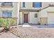 Close up of home's front door showing neutral stucco facade and minimal landscaping at 1021 Gary Carmena Ave, North Las Vegas, NV 89081