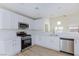 Bright kitchen with stainless steel appliances, white cabinets, and white countertop at 1021 Gary Carmena Ave, North Las Vegas, NV 89081