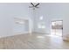 Spacious living room with wood floors and sliding glass doors to the backyard at 1021 Gary Carmena Ave, North Las Vegas, NV 89081