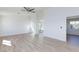 Large living room featuring wood flooring, light fixtures, and windows for natural light at 1021 Gary Carmena Ave, North Las Vegas, NV 89081
