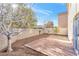 Private backyard with a concrete patio, gravel landscaping, and block wall fencing at 10510 Mojave Ridge Ct, Las Vegas, NV 89183