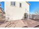 Exterior view of the home with a concrete patio and sliding glass door to the backyard at 10510 Mojave Ridge Ct, Las Vegas, NV 89183