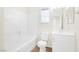 All-white bathroom with a shower-tub combination and modern fixtures at 10510 Mojave Ridge Ct, Las Vegas, NV 89183