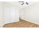 Bedroom features wood-look floors, neutral walls, closet and ceiling fan at 10510 Mojave Ridge Ct, Las Vegas, NV 89183
