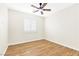 Bright bedroom with wood-look floors, neutral walls, and a ceiling fan at 10510 Mojave Ridge Ct, Las Vegas, NV 89183