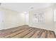 Bright bedroom with wood-look flooring, window with shutters, and white trim throughout at 10510 Mojave Ridge Ct, Las Vegas, NV 89183
