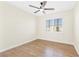 A bright bedroom with wood-look floors, neutral walls, and a ceiling fan at 10510 Mojave Ridge Ct, Las Vegas, NV 89183
