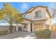 Charming two-story home with desert landscaping, covered porch, and attached two-car garage at 10510 Mojave Ridge Ct, Las Vegas, NV 89183