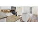 Modern kitchen with granite countertops, backsplash, stainless steel appliances, and center island at 10510 Mojave Ridge Ct, Las Vegas, NV 89183