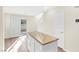 Bright kitchen features an island with granite countertop, white cabinets and stainless steel appliances at 10510 Mojave Ridge Ct, Las Vegas, NV 89183