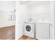 Bright laundry room with white washer and dryer, and wire shelving at 10510 Mojave Ridge Ct, Las Vegas, NV 89183