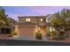 Charming two-story home featuring a terra-cotta roof, attached garage, and low maintenance desert landscaping at 11344 Espadrille Ct, Las Vegas, NV 89138