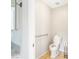 Powder room featuring a toilet, sink with granite countertop, tiled floors, and neutral-colored walls at 124 Beach Oak Ave, Henderson, NV 89002