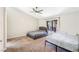 Neutral bedroom with a ceiling fan, carpet, and slider access to outdoor patio at 124 Beach Oak Ave, Henderson, NV 89002
