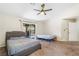 Bedroom featuring a ceiling fan, carpet, and sliding glass door access to the outdoor patio at 124 Beach Oak Ave, Henderson, NV 89002