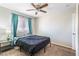 Bedroom with carpeted floors, ceiling fan, and a window with curtains at 124 Beach Oak Ave, Henderson, NV 89002
