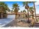 Charming single story home with a two-car garage and desert landscaping at 124 Beach Oak Ave, Henderson, NV 89002