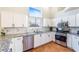 Well-lit kitchen features white cabinetry, stainless steel appliances, granite counters, and decorative backsplash at 124 Beach Oak Ave, Henderson, NV 89002