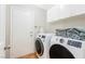 Laundry room with washer, dryer, cabinets and tile floors at 124 Beach Oak Ave, Henderson, NV 89002