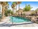 Beautiful pool with tropical landscaping, rock border and metal handrail creates a backyard oasis at 124 Beach Oak Ave, Henderson, NV 89002