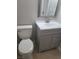 Cozy bathroom featuring a modern gray vanity, a white toilet, and neutral walls at 1309 Exley Ave, Las Vegas, NV 89104